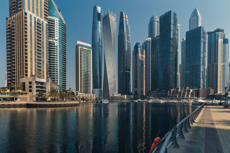 Explore the towering skyscrapers of Dubai Marina reflecting beautifully on the water.